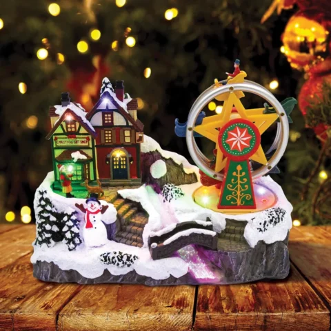 Light-up snowy Christmas village with a revolving Ferris wheel