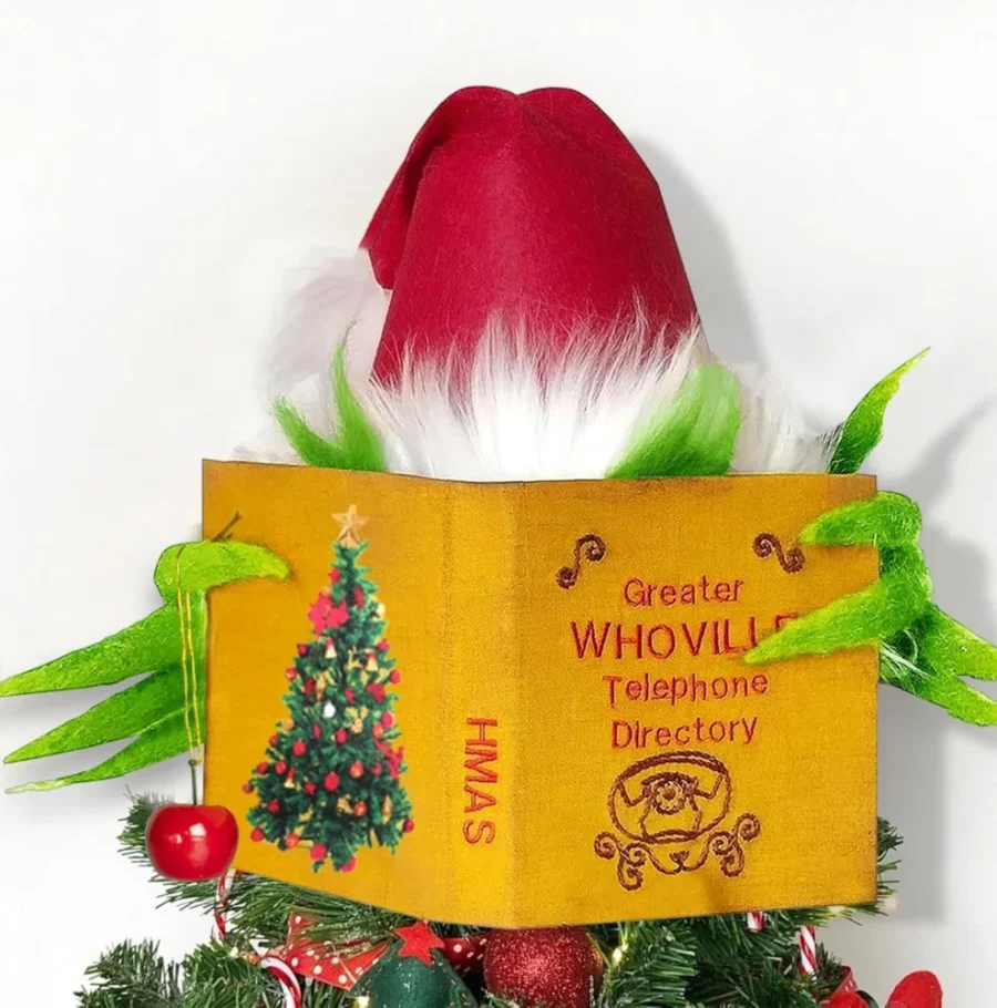 Whoville-style plush elf tree topper behind a book, 30 cm tall